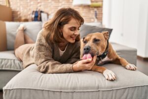 dog licking woman's hand