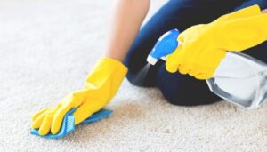 Spraying carpet cleaner on the carpet