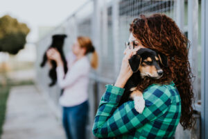 Two womans volunteering in a dog shelter