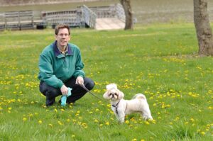 Clean Up After Your Pet - A man and a dog in the park